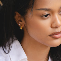 Gold Dome Huggies worn in everyday styling close-up